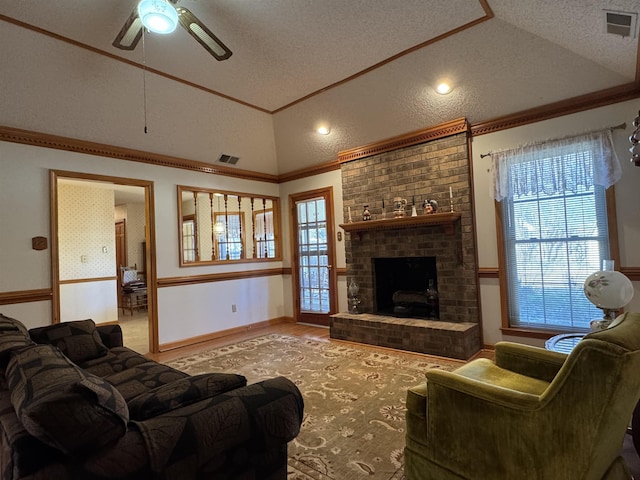 living room with lofted ceiling, a brick fireplace, visible vents, and crown molding