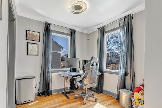 home office featuring ornamental molding, light wood-type flooring, and baseboards