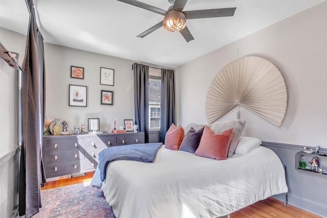 bedroom with ceiling fan and wood finished floors