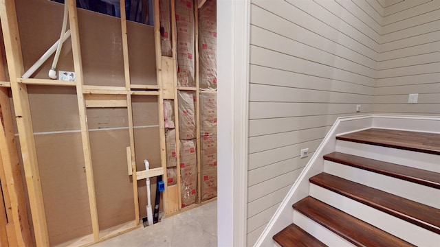 stairs featuring wooden walls