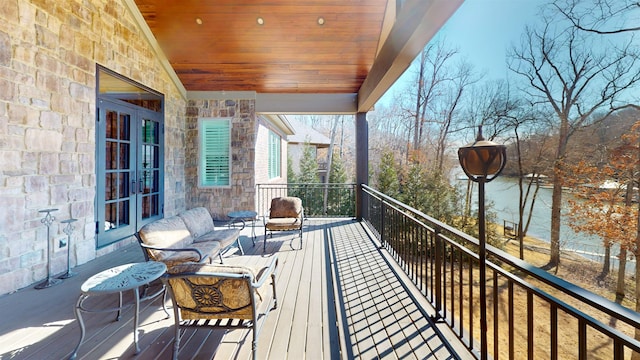 balcony featuring french doors and outdoor lounge area