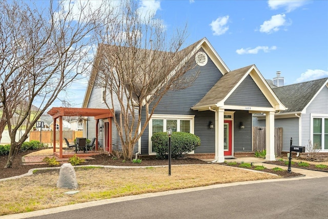 view of front of home with a patio area, fence, and a pergola