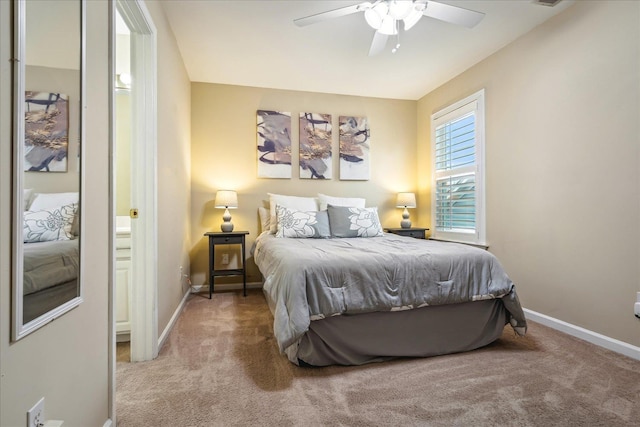 bedroom with a ceiling fan, light carpet, and baseboards