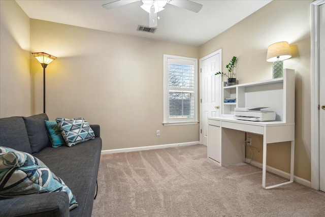 home office with baseboards, visible vents, ceiling fan, and light colored carpet