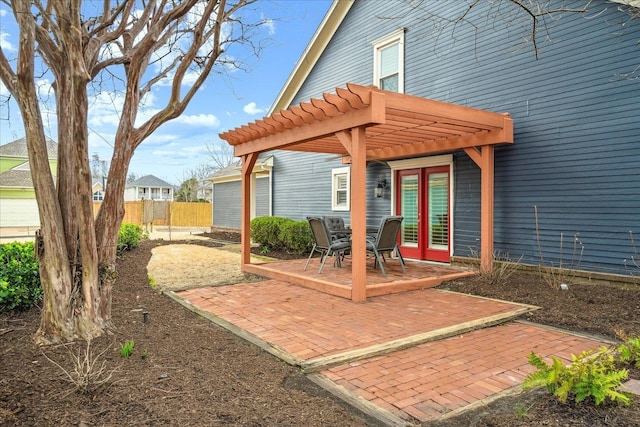 exterior space featuring french doors, fence, and a pergola