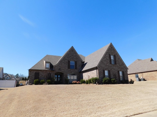 french country home with stone siding