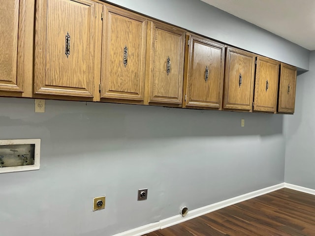 laundry area with dark wood-style flooring, hookup for a washing machine, cabinet space, electric dryer hookup, and baseboards