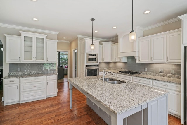 kitchen with appliances with stainless steel finishes, a sink, and white cabinets