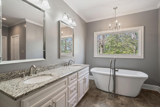 bathroom featuring crown molding, a freestanding tub, and a sink