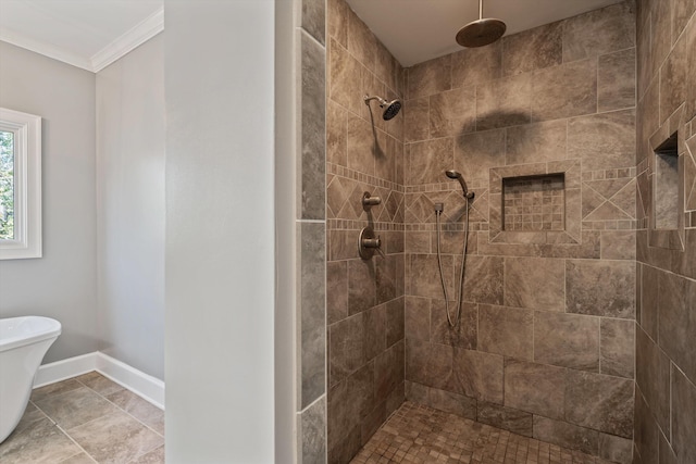 bathroom featuring baseboards, tiled shower, and crown molding