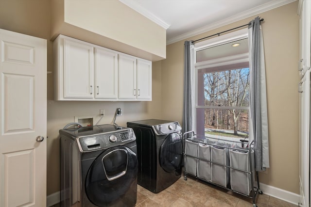 washroom with cabinet space, crown molding, baseboards, and separate washer and dryer