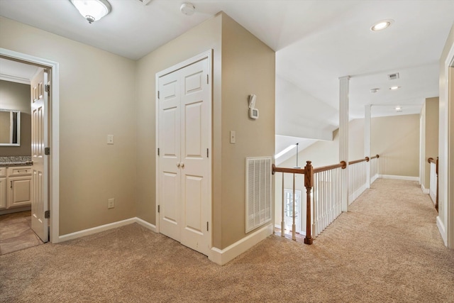 hallway with recessed lighting, baseboards, visible vents, and light colored carpet