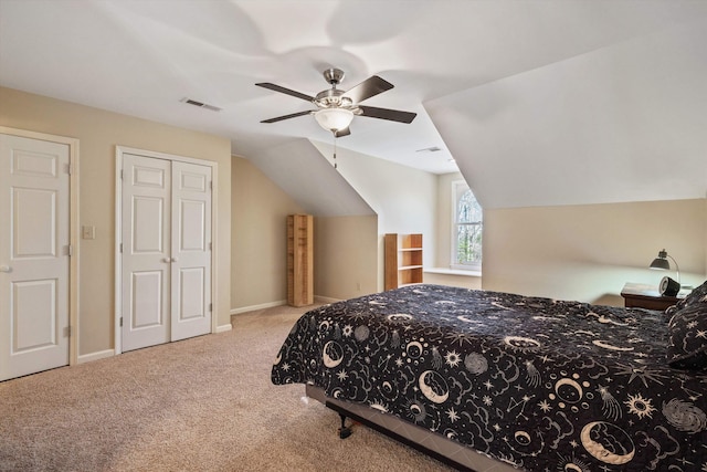 carpeted bedroom with lofted ceiling, ceiling fan, visible vents, and baseboards