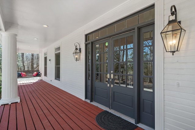 view of exterior entry featuring covered porch