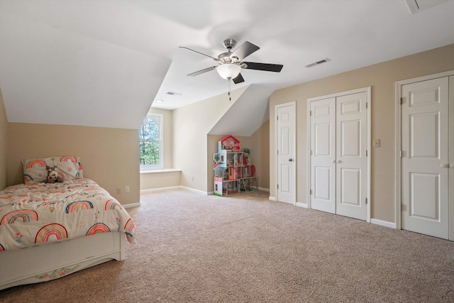 bedroom featuring carpet floors, baseboards, visible vents, and vaulted ceiling