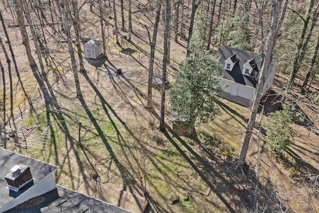 birds eye view of property with a forest view