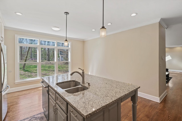 kitchen with decorative light fixtures, crown molding, appliances with stainless steel finishes, dark wood-type flooring, and a sink