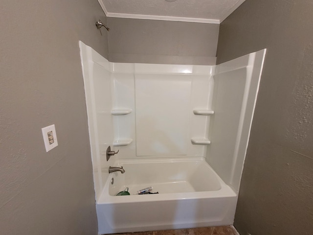 full bath featuring a textured ceiling, a textured wall, and ornamental molding