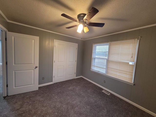 unfurnished bedroom with carpet flooring, crown molding, visible vents, and a textured ceiling