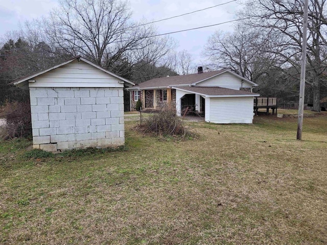 exterior space with a front lawn and an outbuilding