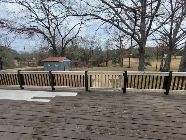 wooden deck featuring an outbuilding and a shed