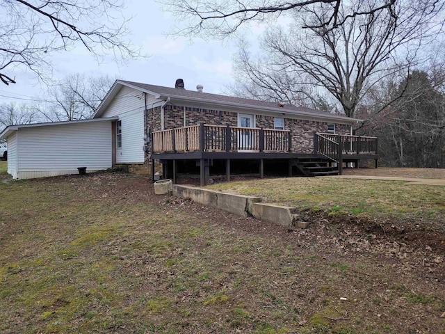 rear view of property with brick siding and a deck