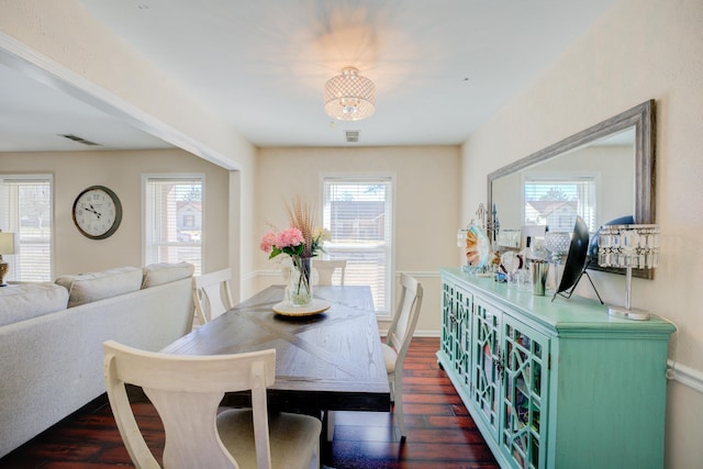 dining area with plenty of natural light, visible vents, and dark wood-style flooring