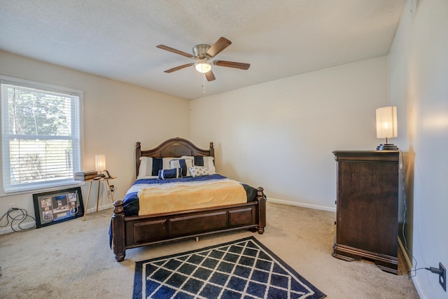 bedroom featuring ceiling fan, a textured ceiling, baseboards, and carpet flooring