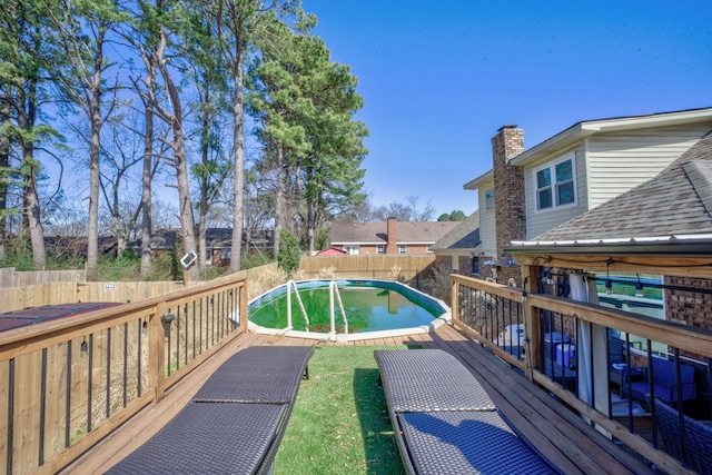 deck featuring a fenced in pool and a fenced backyard