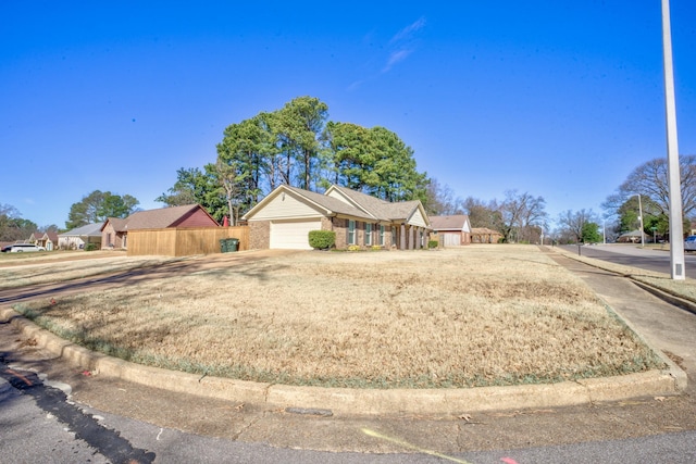 ranch-style home featuring a garage, concrete driveway, and brick siding