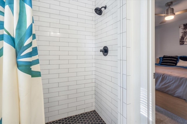 ensuite bathroom featuring connected bathroom, a tile shower, and ceiling fan