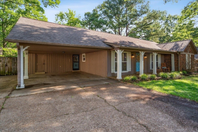 single story home with a shingled roof, fence, a porch, and aphalt driveway