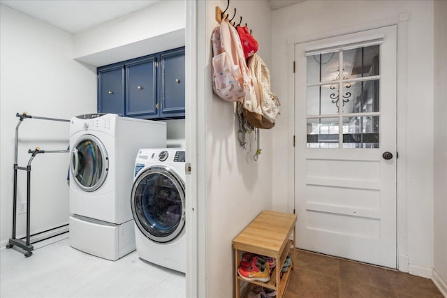 laundry area with independent washer and dryer and cabinet space