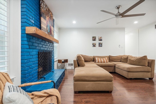 living room featuring a ceiling fan, recessed lighting, a fireplace, and wood finished floors