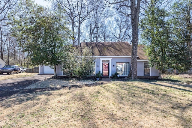 view of front of house with a front yard, driveway, and fence