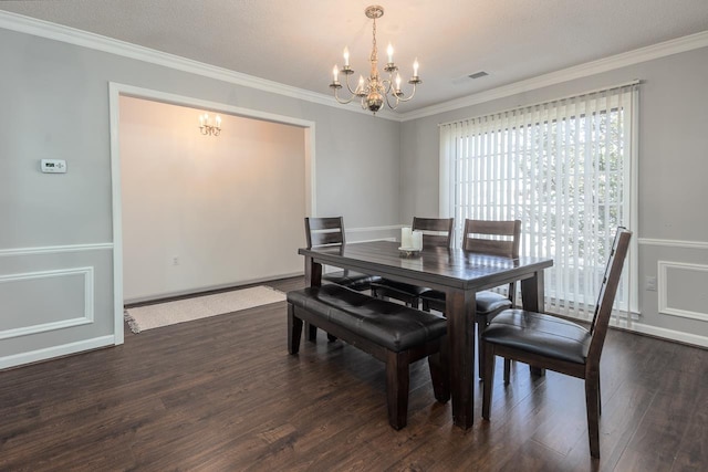 dining area featuring ornamental molding, dark wood finished floors, visible vents, and a notable chandelier