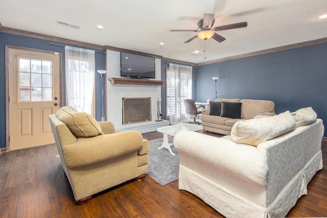 living area with dark wood-style floors, crown molding, plenty of natural light, and visible vents