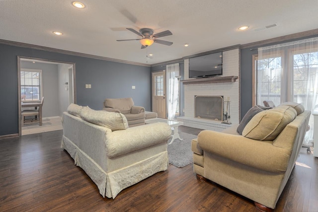 living room featuring a wealth of natural light, dark wood-style flooring, crown molding, and baseboards