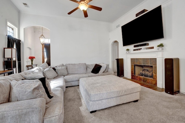 living room with visible vents, arched walkways, and ornamental molding