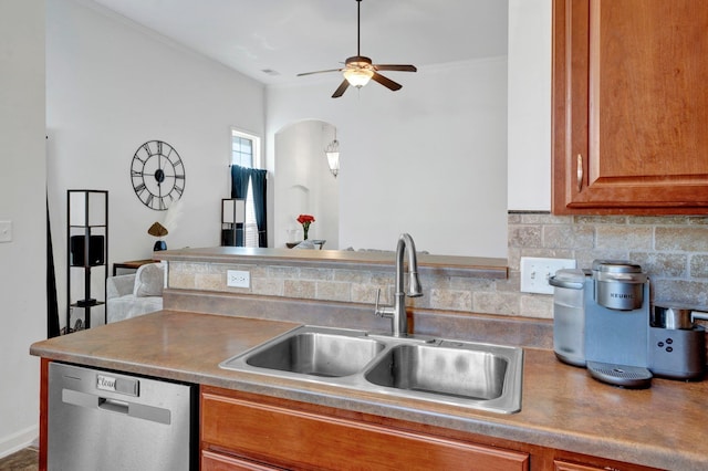 kitchen with dishwasher, backsplash, brown cabinets, a peninsula, and a sink