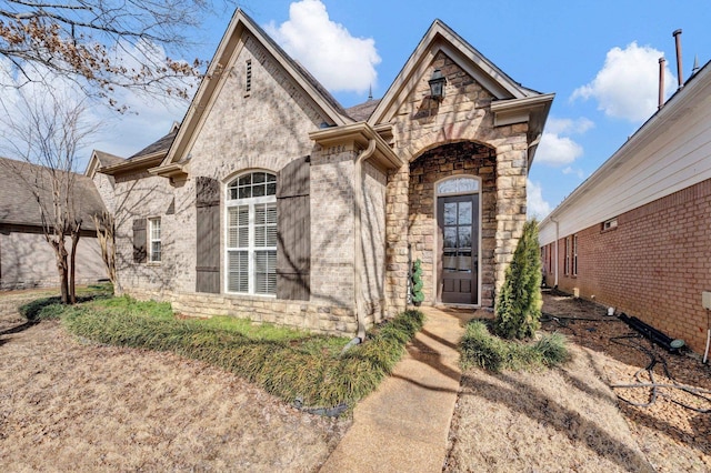 view of front of property with stone siding and brick siding