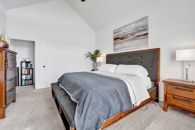 carpeted bedroom with high vaulted ceiling