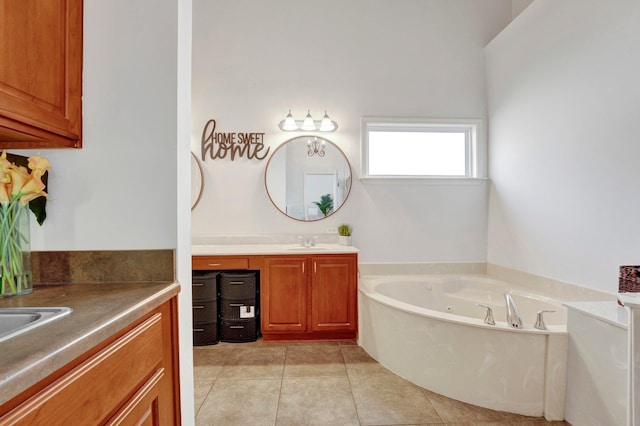 full bathroom featuring tile patterned flooring, two vanities, a sink, and a tub with jets