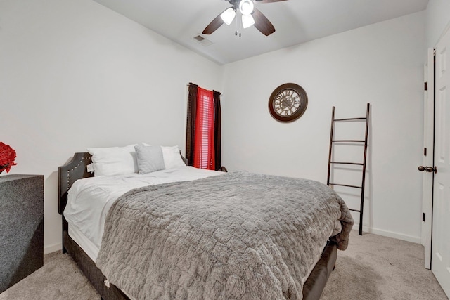 bedroom with light carpet, ceiling fan, visible vents, and baseboards