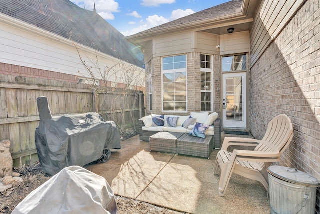 view of patio / terrace featuring a grill, outdoor lounge area, and fence