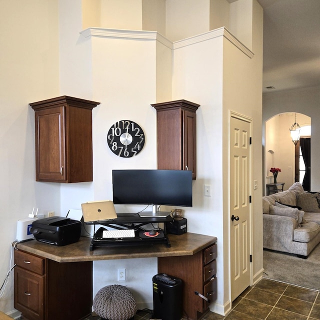 home office featuring arched walkways, dark tile patterned flooring, and dark carpet