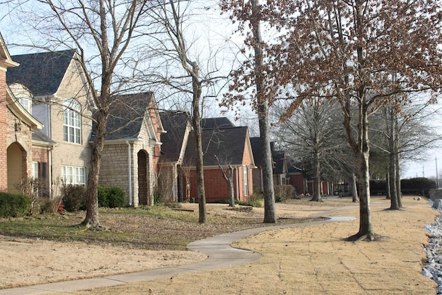 view of front of home with brick siding and a residential view