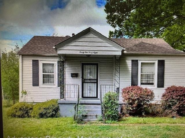 bungalow-style house with covered porch and roof with shingles