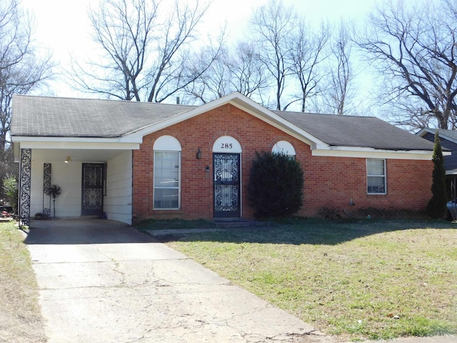 ranch-style house with driveway, a front lawn, and brick siding