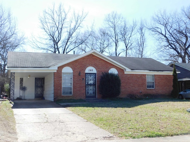 single story home featuring driveway, a shingled roof, a front lawn, and brick siding